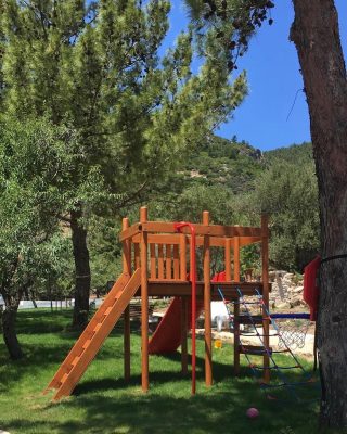 Aire de jeux en bois avec toboggans rouges — Elysee