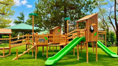 Aire de jeux en bois naturel avec toboggans verts — Elysee